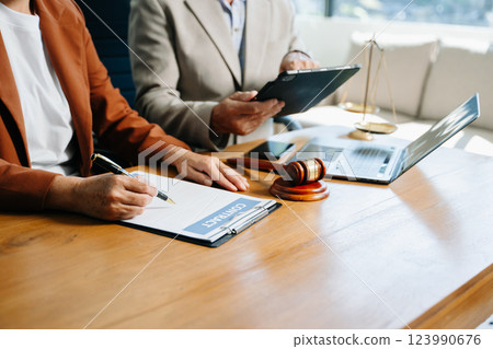 business people and lawyers discussing contract papers sitting at the table. Concepts 123990676