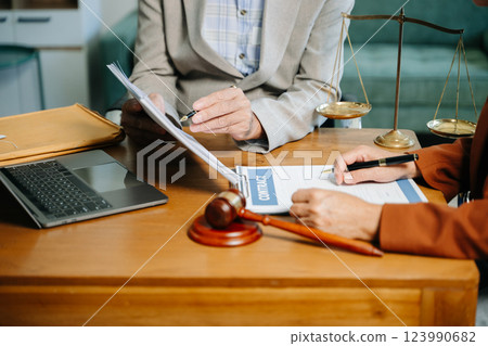 business people and lawyers discussing contract papers sitting at the table. Concepts business people and lawyers discussing contract papers sitting at the table. Concepts 123990682