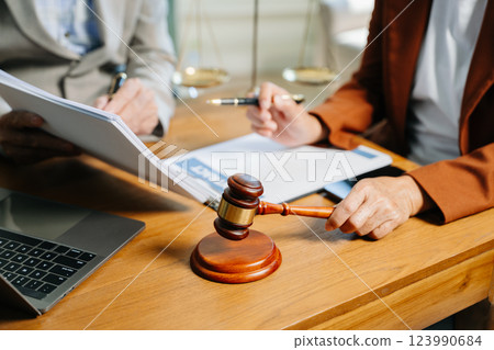 business people and lawyers discussing contract papers sitting at the table. Concepts business people and lawyers discussing contract papers sitting at the table. Concepts 123990684