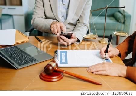 business people and lawyers discussing contract papers sitting at the table. Concepts business people and lawyers discussing contract papers sitting at the table. Concepts 123990685