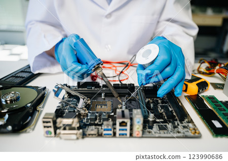 The technician repairing the motherboard in the lab with copy space. the concept The technician repairing the motherboard in the lab with copy space. the concept 123990686