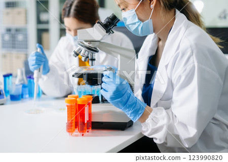 Scientists, beakers, and microscopes in cutting-edge research. Perfect for science and technology projects. 123990820