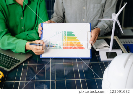 Engineers collaborate on solar and wind energy, driving sustainability, innovation, and clean tech solutions. 123991682