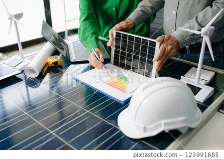 Engineers collaborate on solar and wind energy, driving sustainability, innovation, and clean tech solutions. Engineers collaborate on solar and wind energy, driving sustainability, innovation, and clean tech solutions. 123991685