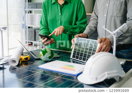 Engineers collaborate on solar and wind energy, driving sustainability, innovation, and clean tech solutions. Engineers collaborate on solar and wind energy, driving sustainability, innovation, and clean tech solutions. 123991689