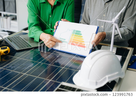 Engineers collaborate on solar and wind energy, driving sustainability, innovation, and clean tech solutions. 123991763