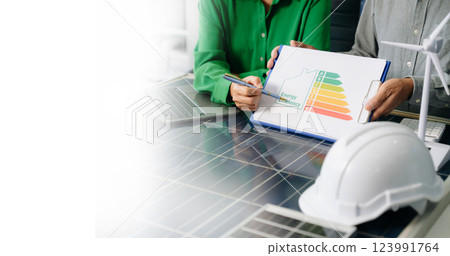 Engineers collaborate on solar and wind energy, driving sustainability, innovation, and clean tech solutions. Engineers collaborate on solar and wind energy, driving sustainability, innovation, and clean tech solutions. 123991764