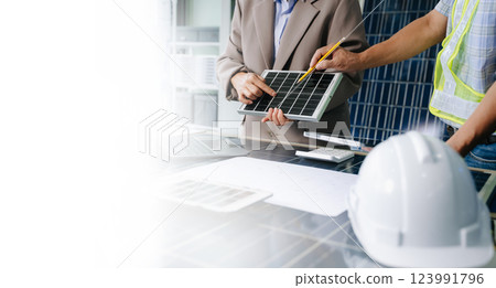 Engineers collaborate on solar and wind energy, driving sustainability, innovation, and clean tech solutions. 123991796