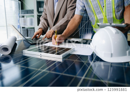 Two engineers collaborate on solar and wind energy, driving clean innovation and sustainability. A vision of teamwork 123991881