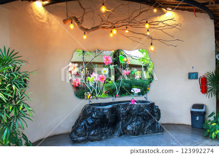 An artistic restroom area combines nature, functionality, and enchanting decorative elements. 123992274