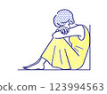 A depressed woman crouching with her knees 123994563