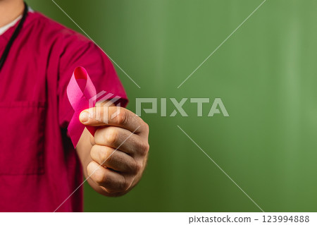 Health advocate displays pink ribbon to raise awareness for breast cancer 123994888