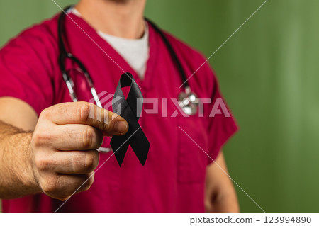 Healthcare worker holds black ribbon in solidarity during health awareness week Healthcare worker holds black ribbon in solidarity during health awareness week 123994890