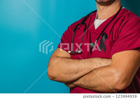 Medical worker in maroon scrubs with stethoscope and support ribbon Medical worker in maroon scrubs with stethoscope and support ribbon 123994939