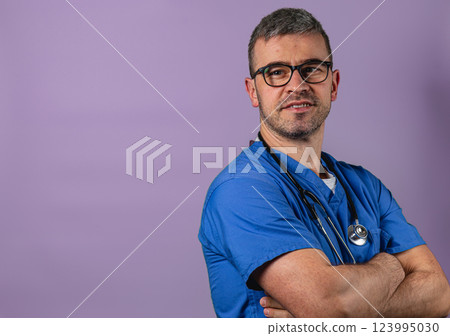 Healthcare professional wearing scrubs with confident expression in the clinic Healthcare professional wearing scrubs with confident expression in the clinic 123995030