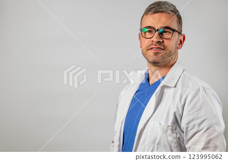 Medical professional in white coat poses for a professional portrait 123995062