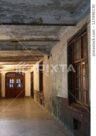 Interior corridor scene with windows and doors in old building 123996136