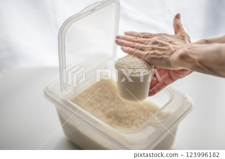 Rice stocker and measuring cup 123996182