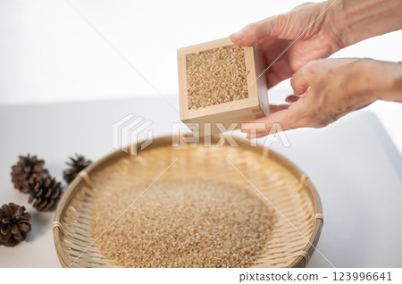 Weigh new brown rice with a wooden box 123996641
