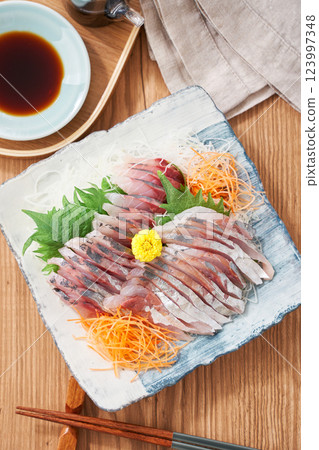 Fresh horse mackerel sashimi served on a plate Fresh horse mackerel sashimi served on a plate 123997348