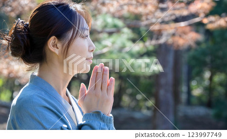 寺廟內祈禱的一名婦女的側影 123997749