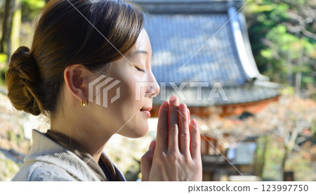 寺廟內祈禱的一名婦女的側影 123997750