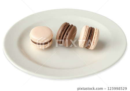 Mocha mousse mousse-filled macarons with delicate, smooth mocha mousse inside soft, chewy macaron shells. The macarons are arranged 123998529