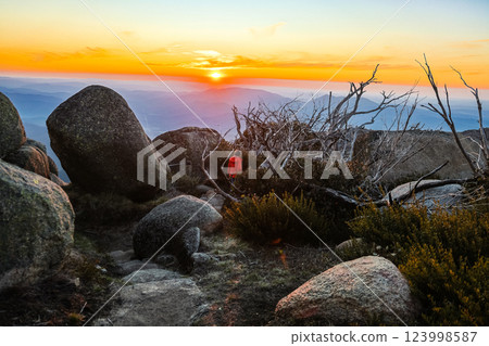 Unrecognized visitor with motion blur hiking the Horn path during sunset at Mount Buffalo National park, Victoria Australia Unrecognized visitor with motion blur hiking the Horn path during sunset at Mount Buffalo National park, Victoria Australia 123998587