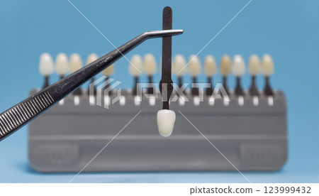 Dental shade guide selection with tweezers 123999432