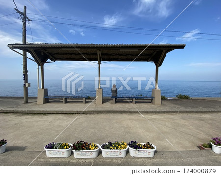 A woman waiting on the platform at Shimonada Station in Ehime Prefecture 124000879