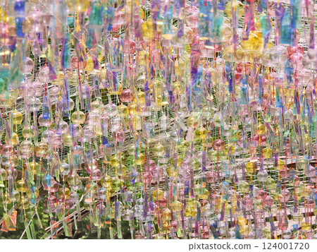 A scene of many hanging glass wind chimes, a symbol of summer A scene of many hanging glass wind chimes, a symbol of summer 124001720