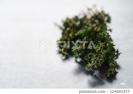Fresh thyme on concrete countertop closeup Fresh thyme on concrete countertop closeup 124001857
