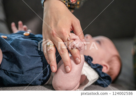 sweet tiny new born baby hand hold mum index finger. concept relationship between mother or parants and baby 124002586