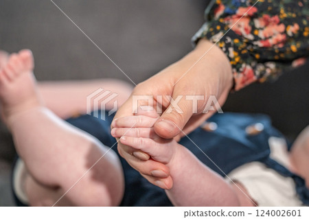 sweet tiny new born baby hand hold mum index finger. concept relationship between mother or parants and baby sweet tiny new born baby hand hold mum index finger. concept relationship between mother or parants and baby 124002601