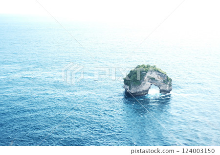 landscape aerial view of Banah Cliff island in calm blue sea of Nusa Penida, Bali, Indonesia 124003150