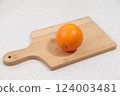Oranges on a cutting board 124003481