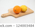 Oranges and lemons on a cutting board 124003484