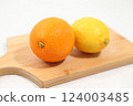 Lemons and oranges served in a wooden bowl 124003485