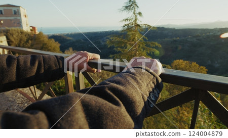 Hands Of An Elderly Man Looking Out At The Country Balcony After Retirement 124004879