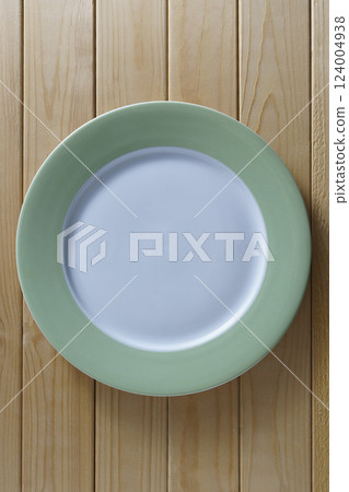 Large empty plate on wooden table Large empty plate on wooden table 124004938