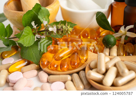 Alternative medicine herbal organic capsule with vitamin E omega 3 fish oil, mineral, drug with herbs leaf natural supplements for healthy good life. 124005787
