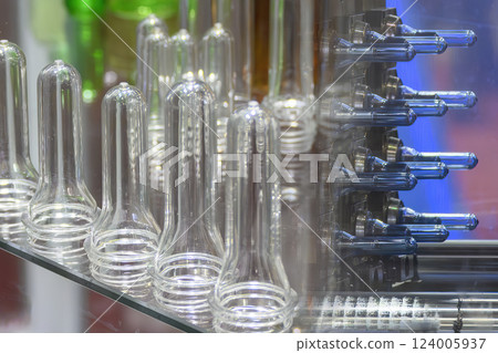 Abstract scene the preform shape of PET bottle products and the injection process background. Abstract scene the preform shape of PET bottle products and the injection process background. 124005937
