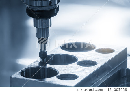 The CNC milling machine chamfer cutting automotive part in the light blue scene. 124005938