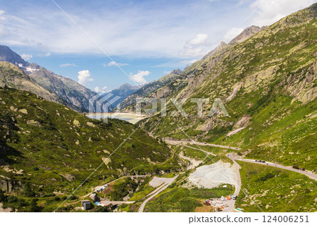 Scenic view of Grimsel Pass winding through the majestic mountains of Switzerland Scenic view of Grimsel Pass winding through the majestic mountains of Switzerland 124006251