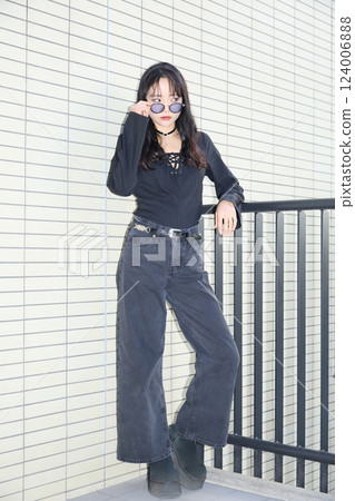 Fashion snap of a young woman wearing black casual outfit Fashion snap of a young woman wearing black casual outfit 124006888