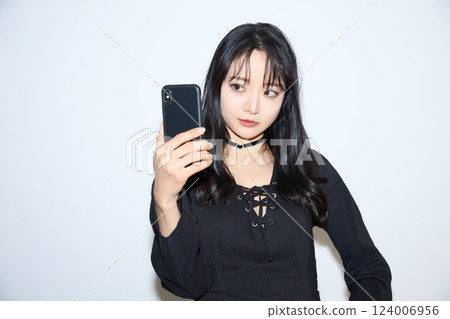Fashion snap of a young woman wearing black casual outfit Fashion snap of a young woman wearing black casual outfit 124006956