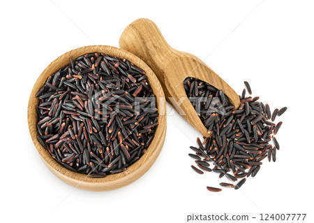 Black wild rice in wooden bowl and scoop isolated on white background close up. Top view. Flat lay Black wild rice in wooden bowl and scoop isolated on white background close up. Top view. Flat lay 124007777