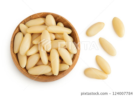 Shelled European pine nuts in wooden bowl isolated on white background with full depth of field. Top view. Flat lay Shelled European pine nuts in wooden bowl isolated on white background with full depth of field. Top view. Flat lay 124007784