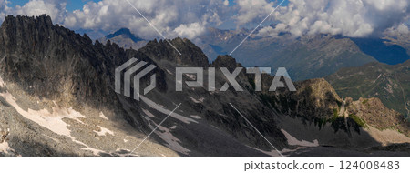 Expansive Panoramic View of Mountain Range Under Cloudy Sky.. 124008483