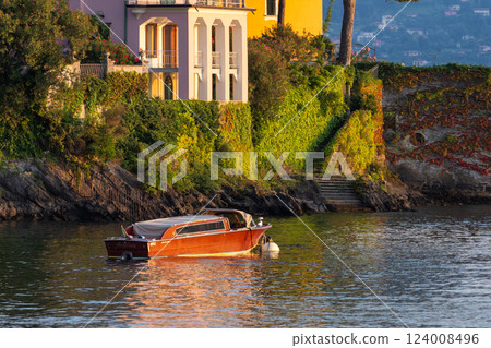 Colorful Lakeside Villas with Boat at Sunset at Varenna, lake Como, Italy 124008496